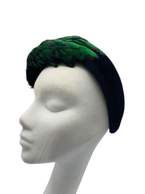 Stunning emerald green and black feather crown with little jewel detail to finish.